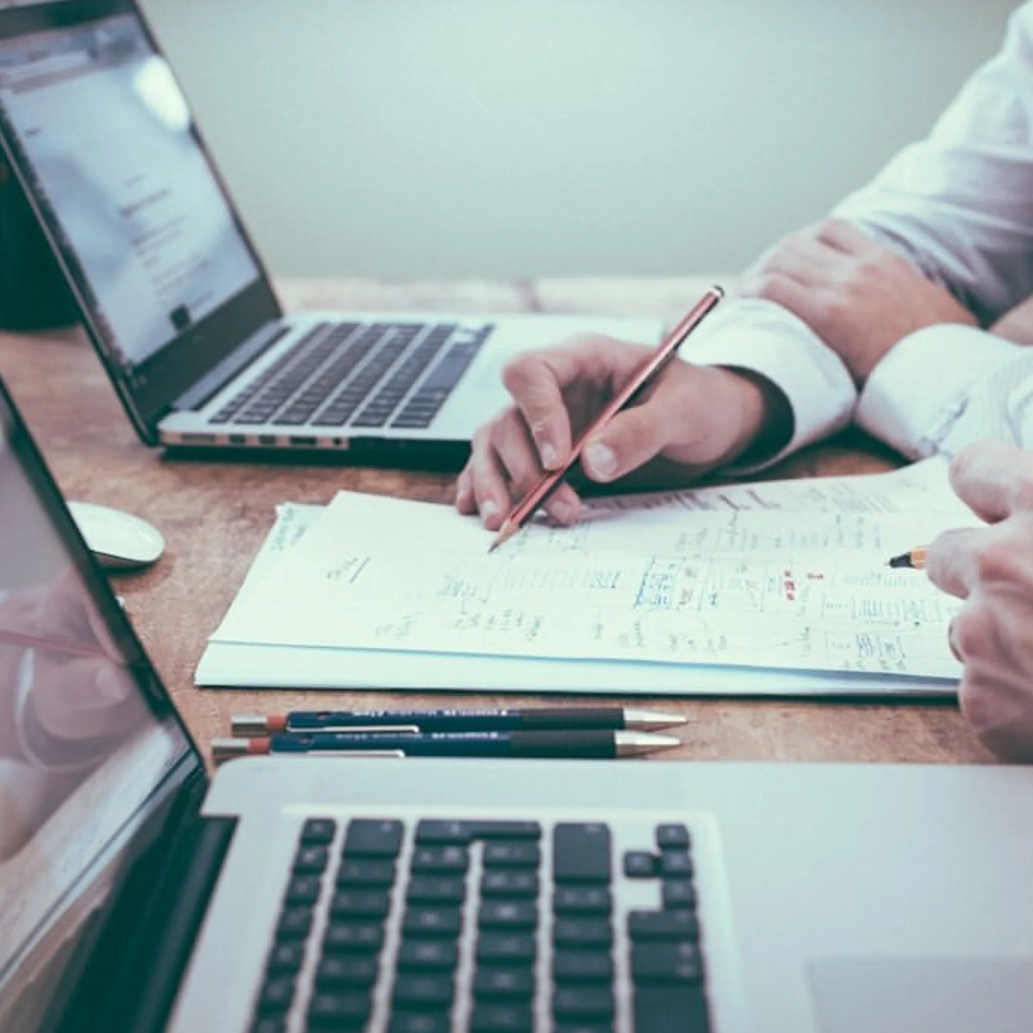 professionals reviewing privacy documents and laptops